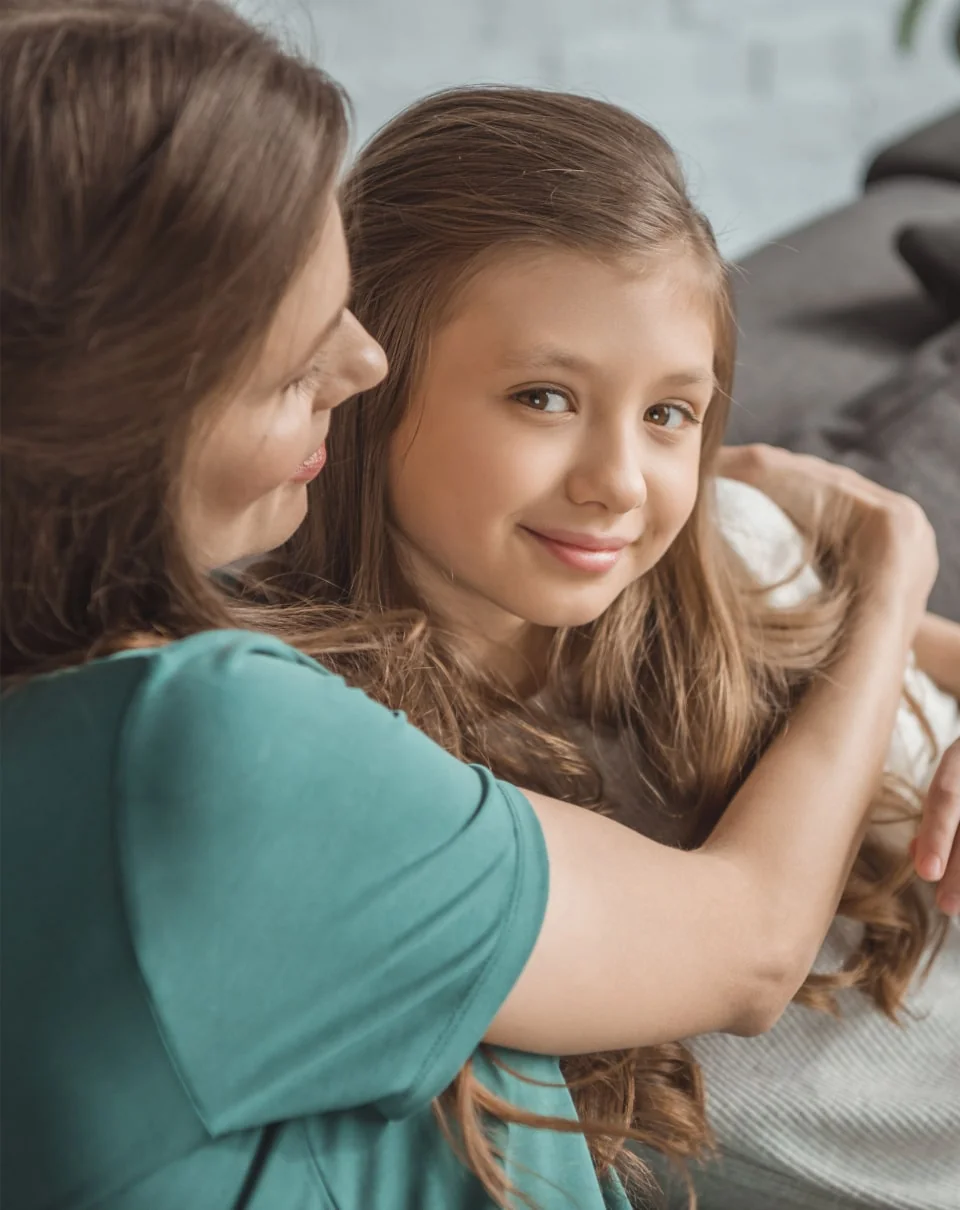 Mother and Daughter hugging on couch